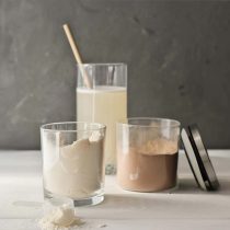 whey-protein-drink-in-a-glass-and-jars-with-protei-2021-12-09-15-14-59-utc_c